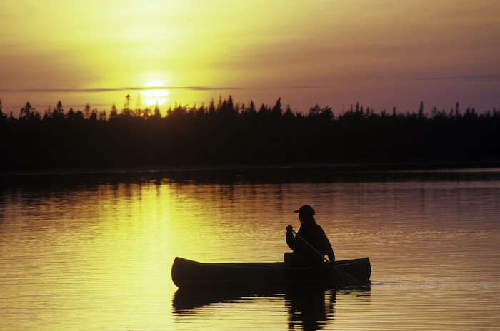 Canoe at sunset, Lobster Lake in Maine North Woods / George Wuerthner