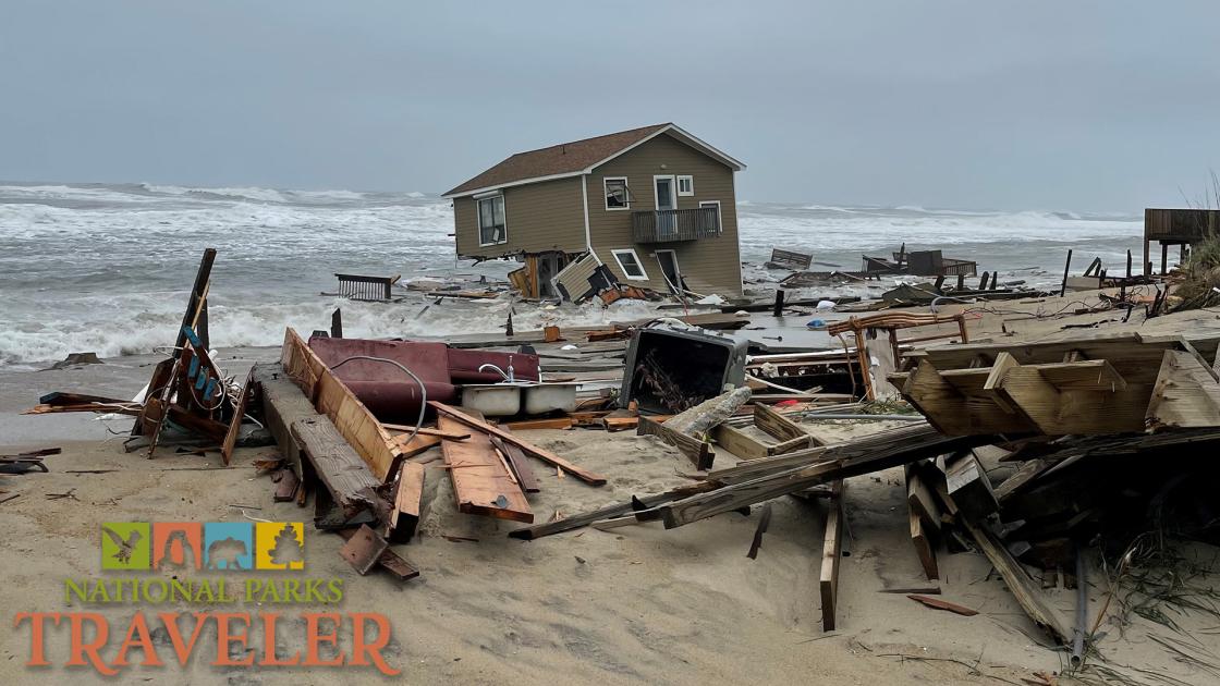 A collapsed house falling into the Atlantic Ocean, surrounded by marine debris. NPS Photo on 5-10-2022.