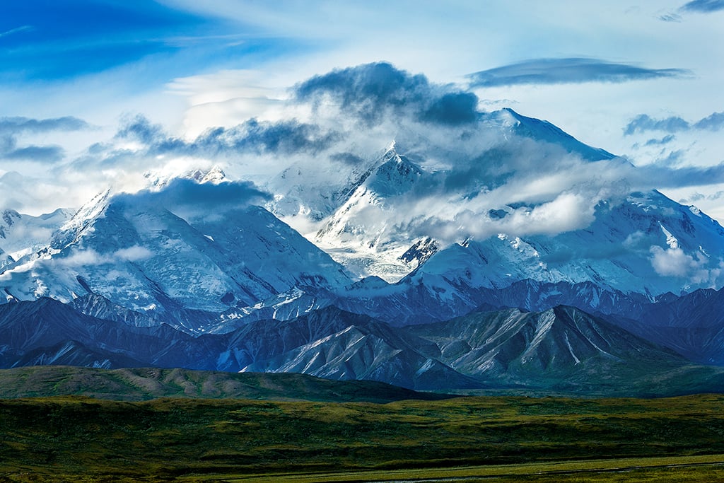 A frame-filling vies of Denali Mountain wreathed by clouds, Denali National Park and Preserve