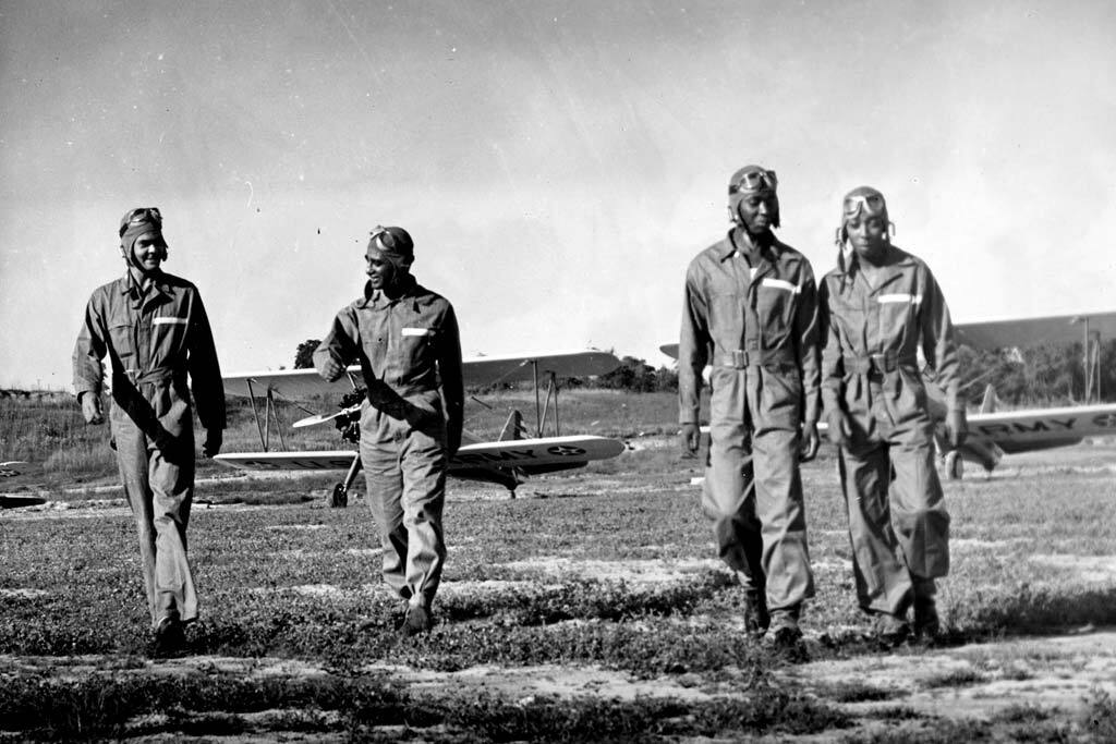 The first class of Tuskegee Airmen Cadets walking away from their Stearman planes, 