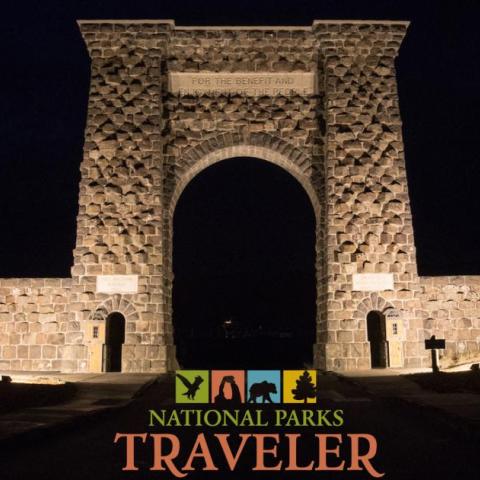 A night time image of the Roosevelt Arch in Yellowstone National Park