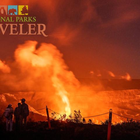 A crowd watching a night time volcano eruption at Hawaii Volcanoes National Park