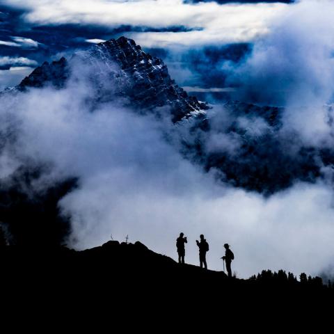 Silhouettes of three hikers on the Pacific Crest Trail. Photo by Igor Pankovcin.