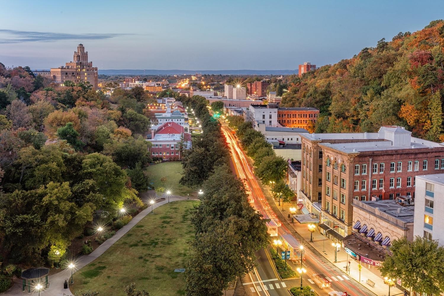 An aerial view of downtown Hot Springs, Arkansas with Hot Springs National Park and "bathhouse row" on the left.