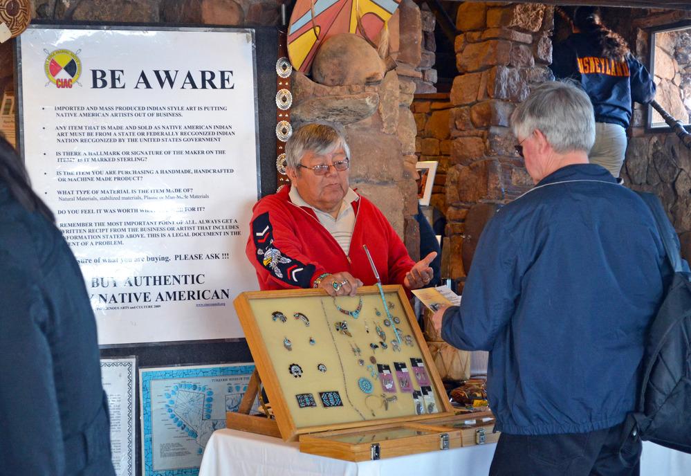 Tony Eriacho, Zuni carver and jeweler is discussing authentic American Indian crafts with park visitor