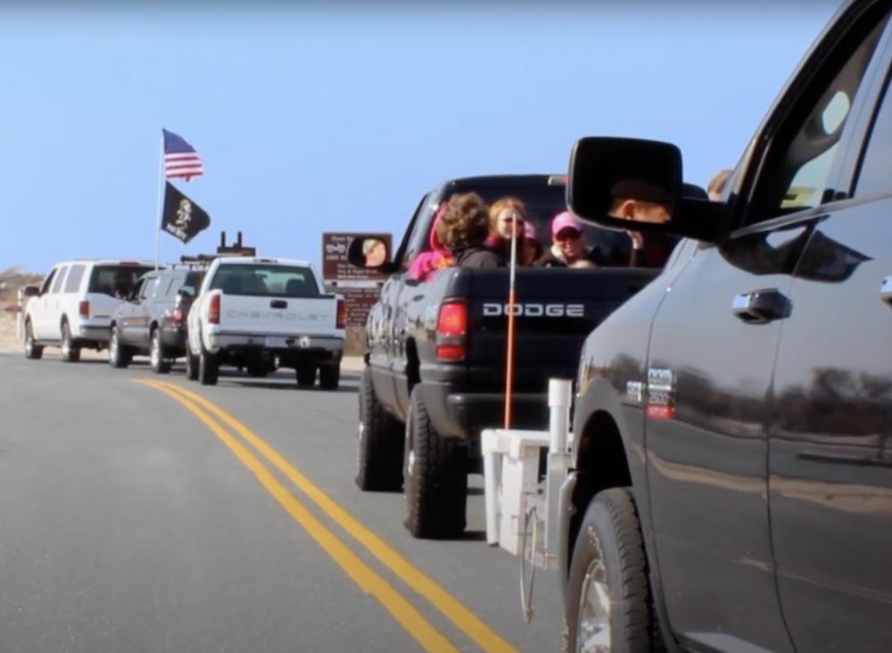 Trucks line up at the entrance to Assateague Island National Seashore in this screenshot from a National Park Service video