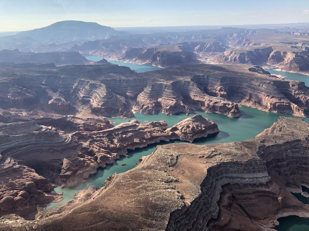 Mountain with layered canyons and lake