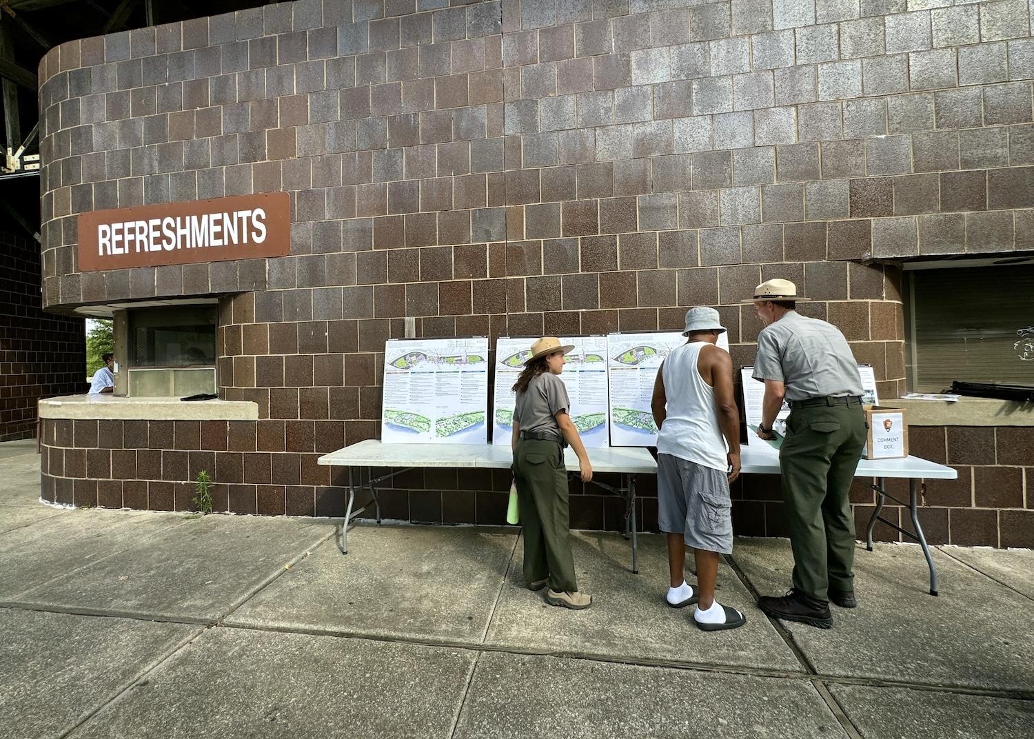 NPS rangers Stephanie Weinstein and Joe Cashman chat with a community member at the Late Skate event about plans to reimagine Anacostia Park.