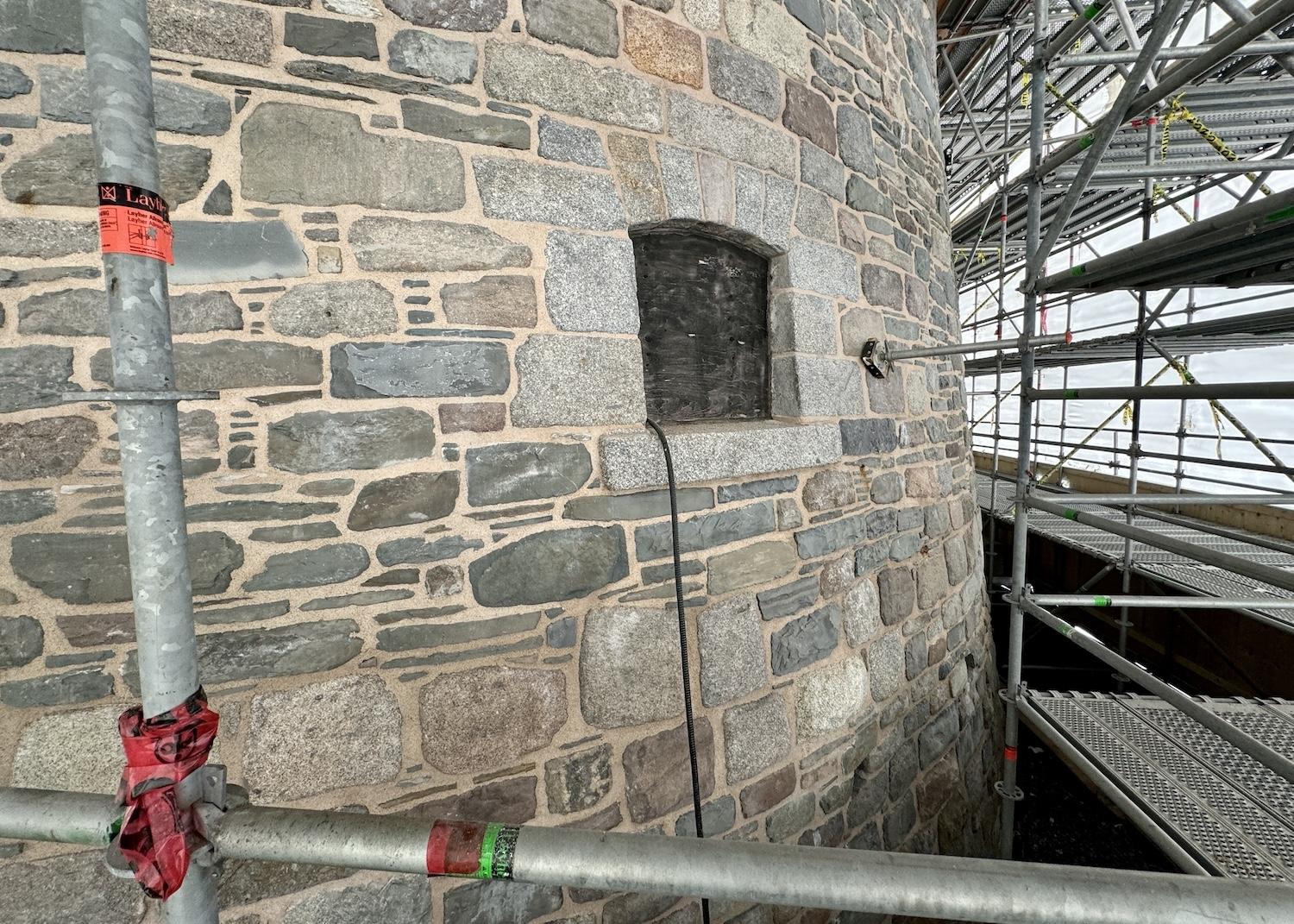 Inside the construction zone, you can see where a heritage window has been removed and where the stones have been removed, cleaned and returned.