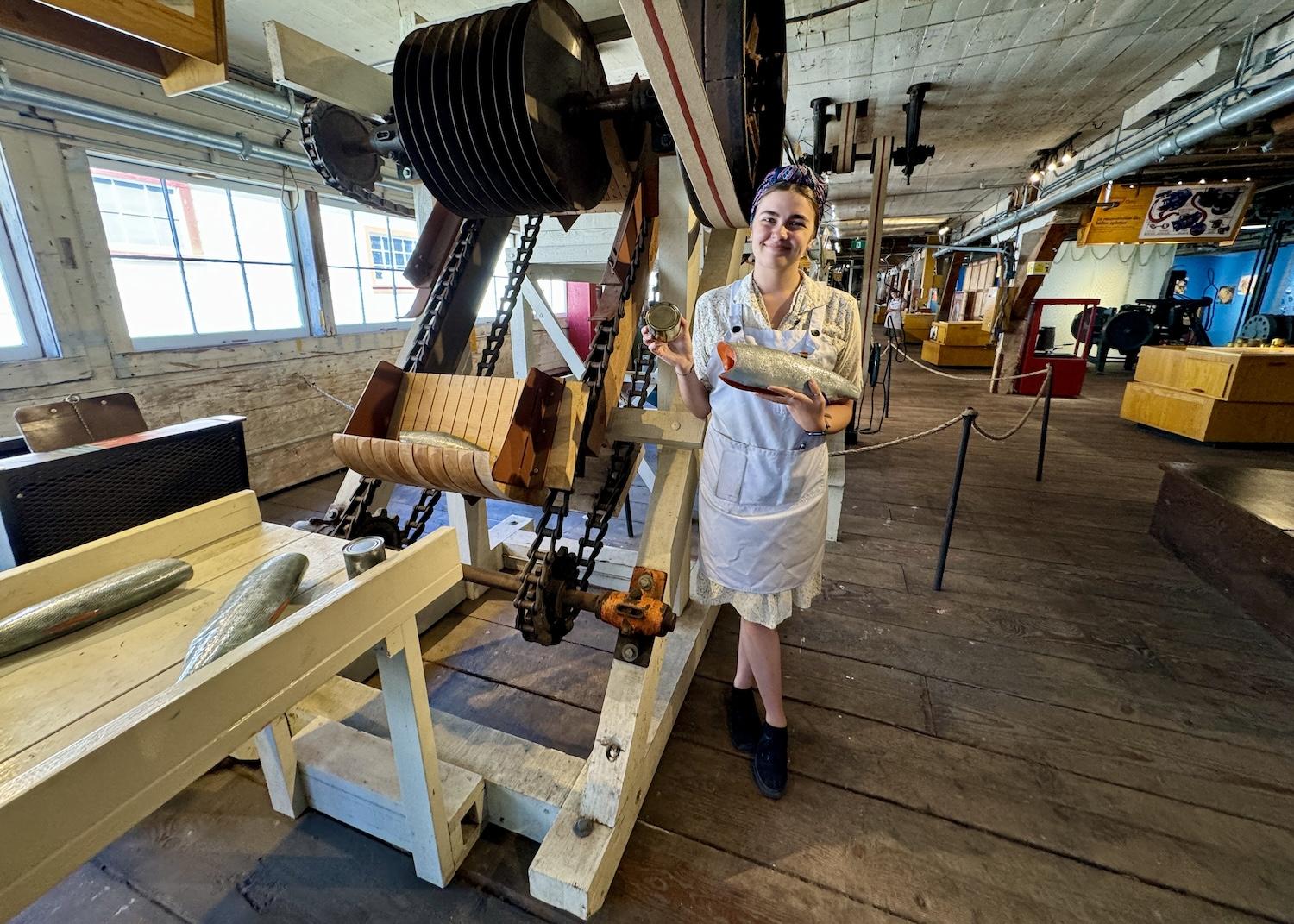 On a "Machine Demo" tour, heritage interpreter Lucy Bosma details how salmon wind up canned.