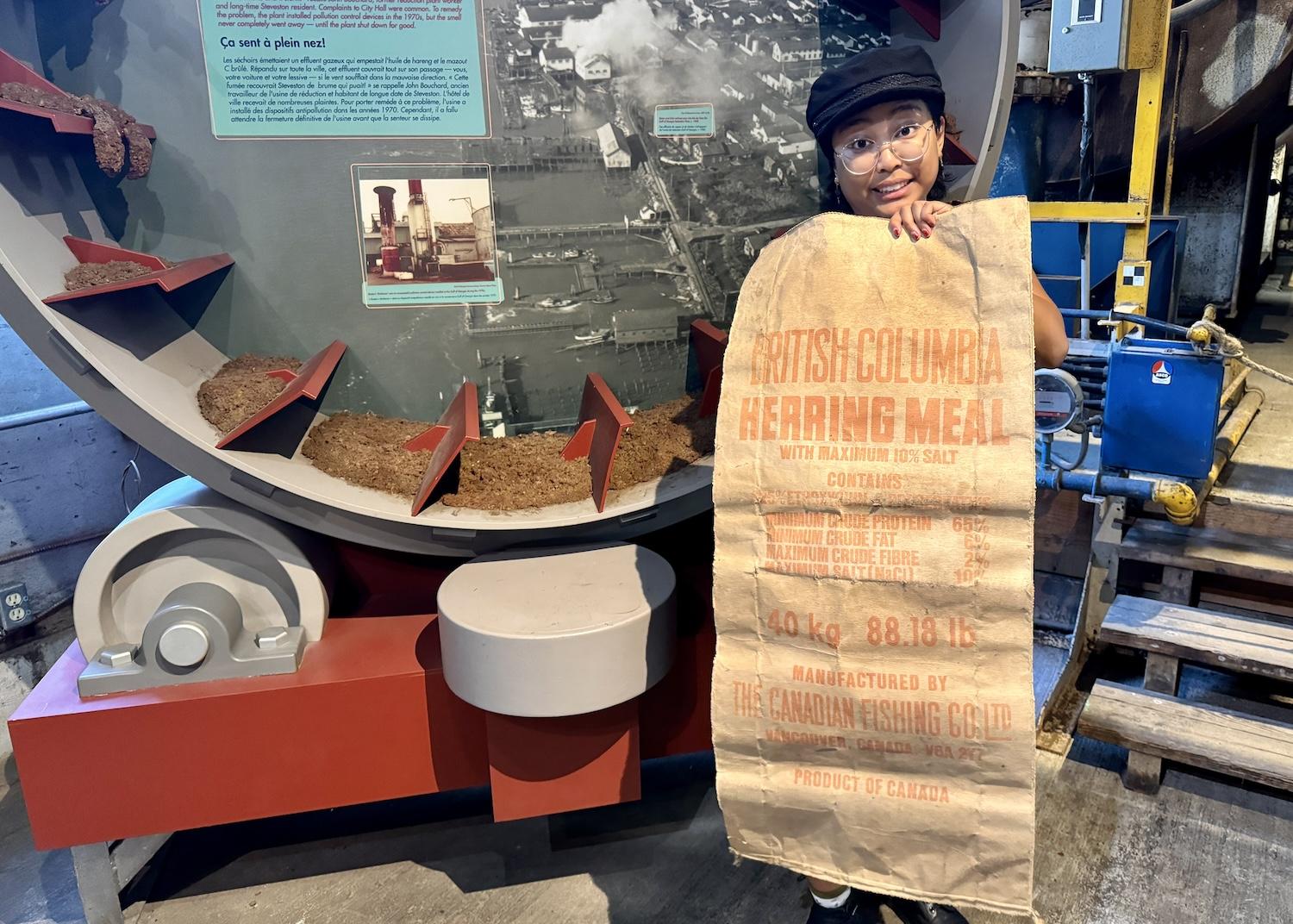 Heritage interpreter Judy Caranto shows how herring wound up becoming herring meal.