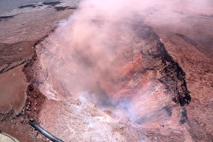 the collapse crater in Pu‘u ‘Ō‘ō. This photo looks to the east, and shows the deep collapse crater formed on Monday, April 30, when magma beneath Pu‘u ‘Ō‘ō drained. For scale, the crater is about 250 meters (820 feet) wide.