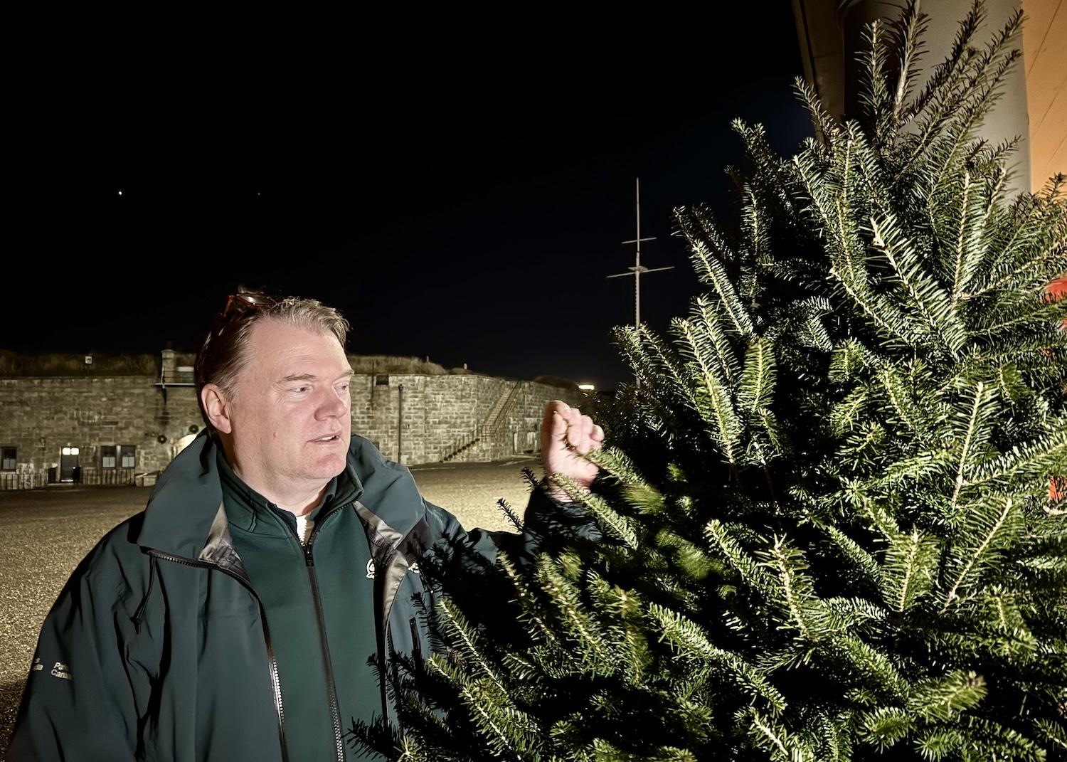 Parks Canada's Hal Thompson shows off one of the simple fir trees at the Halifax Citadel during the Christmas season.