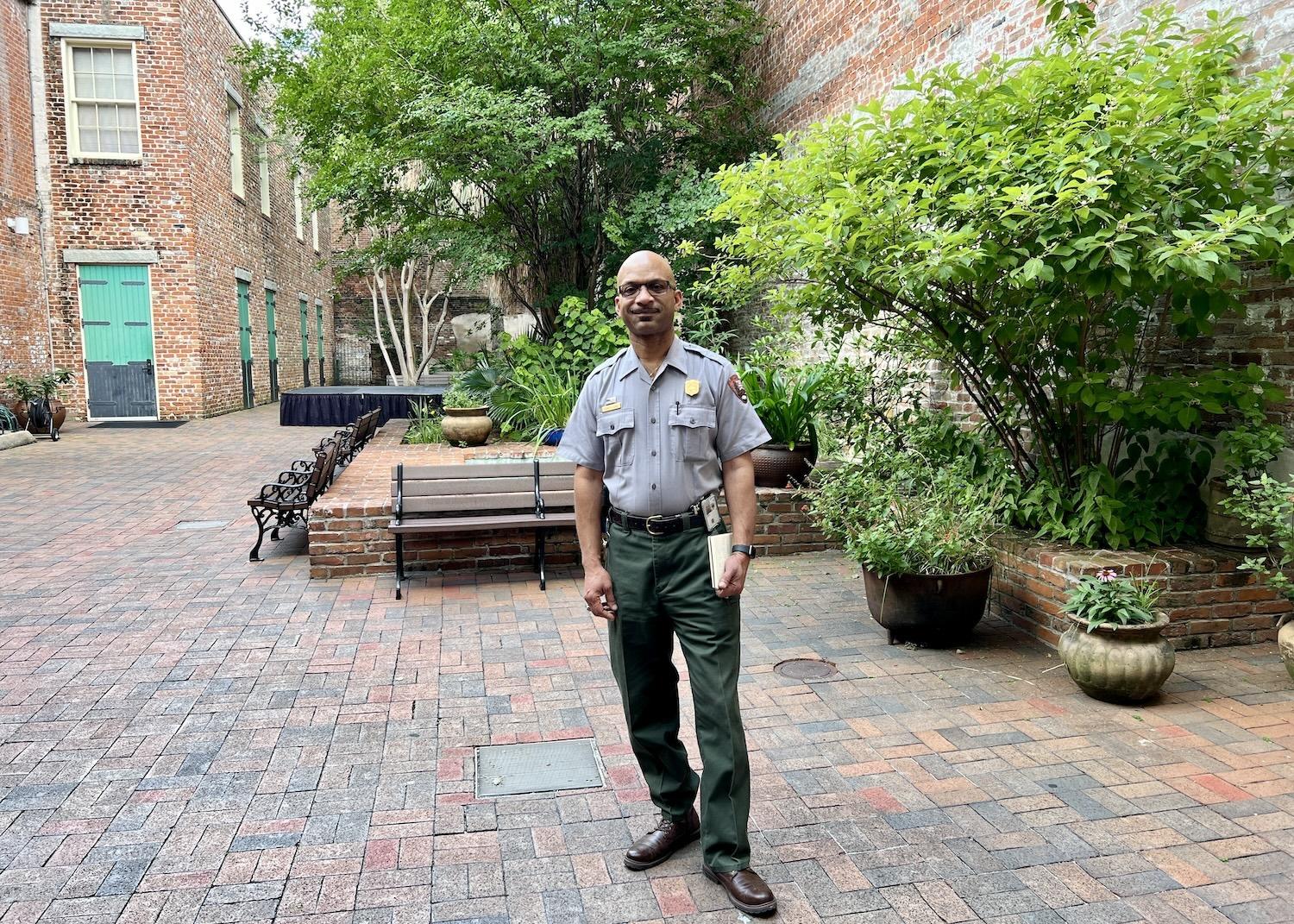 Jazz ranger Kerry Lewis stands in the French Quarter courtyard of the visitor center for New Orleans Jazz and Jean Latiffe national historical parks.