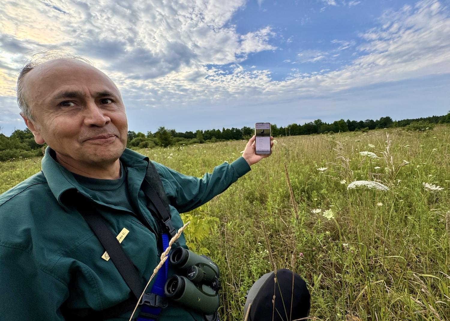 When we don't see or hear Bobolinks, Parks Canada ecologist calls up photos and recordings on his phone.