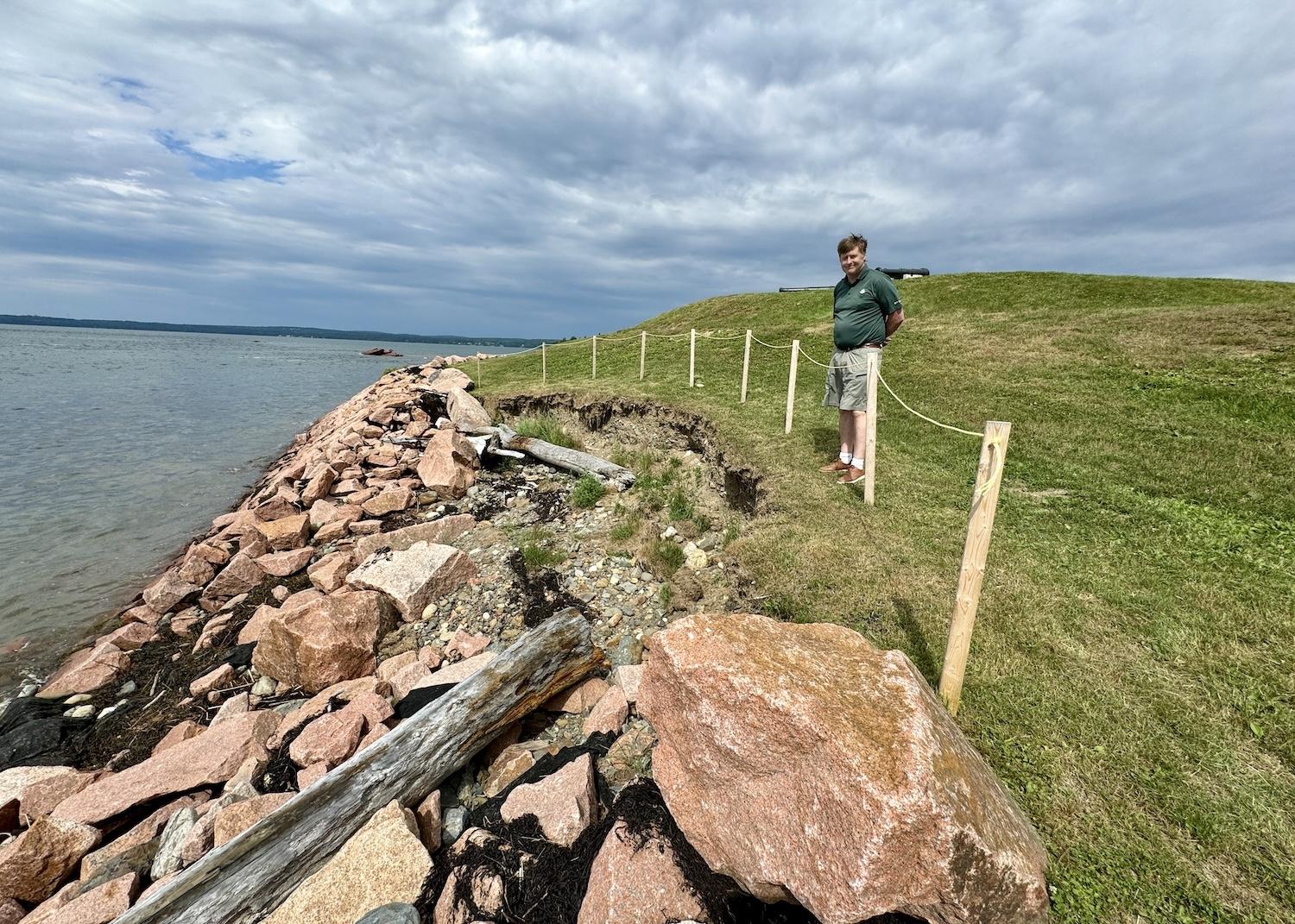 Parks Canada's Kurt Peacock shows how the agency has tried to make the shoreline more resilient to climate change at St. Andrews Blockhouse.