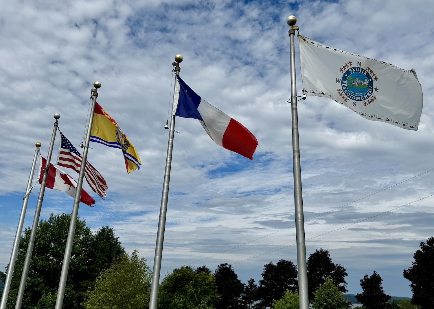 Five flags, including one for the Indigenous Peoples who first lived in what's now New Brunswick, fly at Canada's Saint Croix Island National Historic Site.