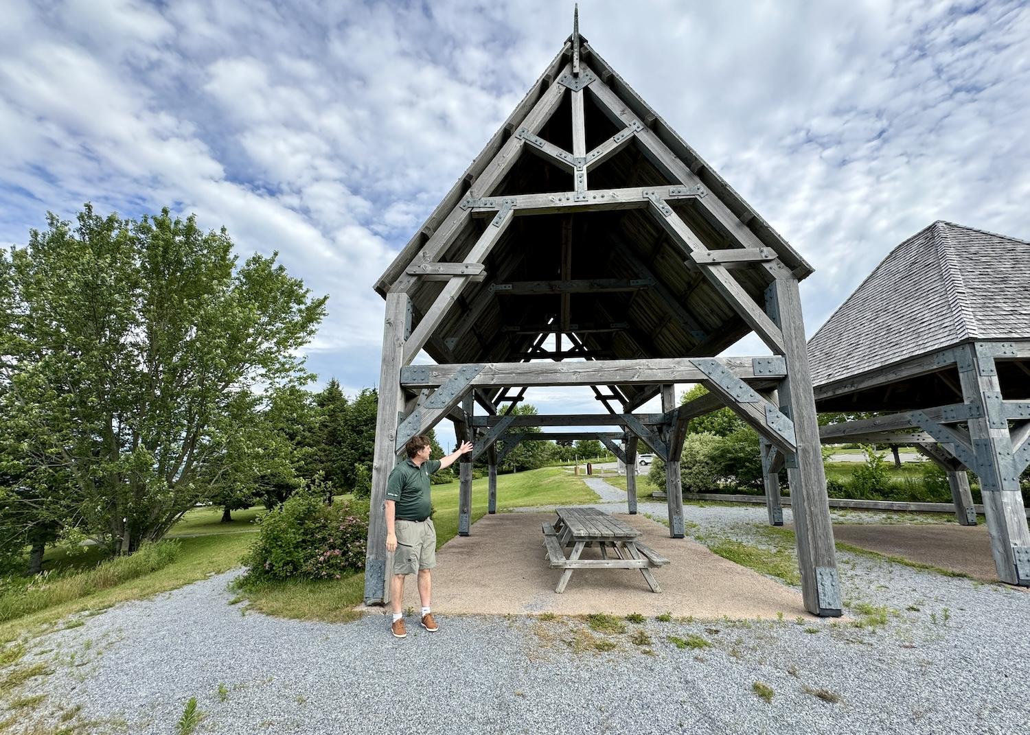 Parks Canada's Kurt Peacock stands in a picnic shelter meant to evoke a kitchen shelter.