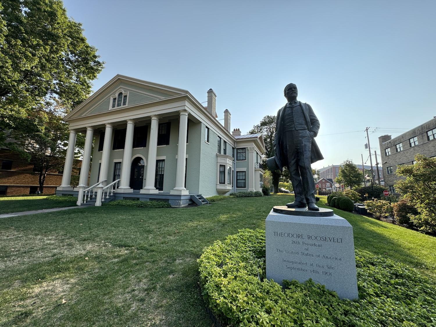 On Delaware Avenue, a statue of Theodore Roosevelt stands on the lawn outside Theodore Roosevelt Inaugural National Historic Site.