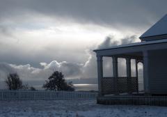 A grey and white snow squall seen from the Officers Quarters of American Camp at San Juan Island National Historical Park